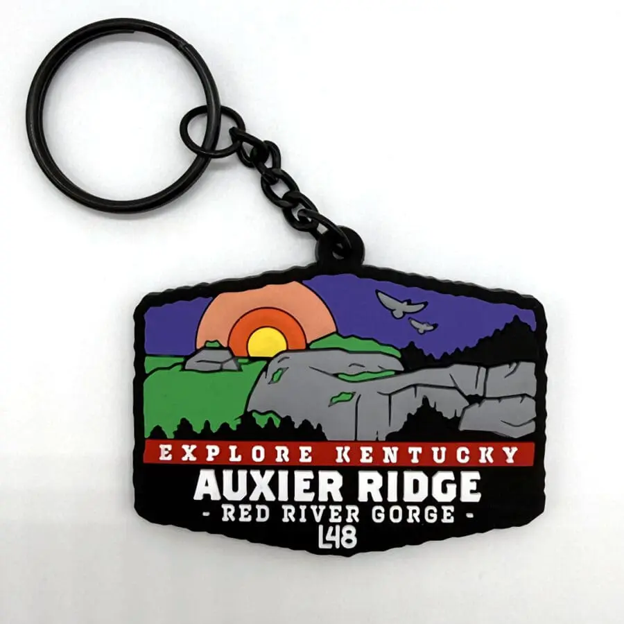 Keychain Featuring a Stylized Landscape of Auxier Ridge at Red River Gorge, Kentucky, with a Sunset and Bold Text.