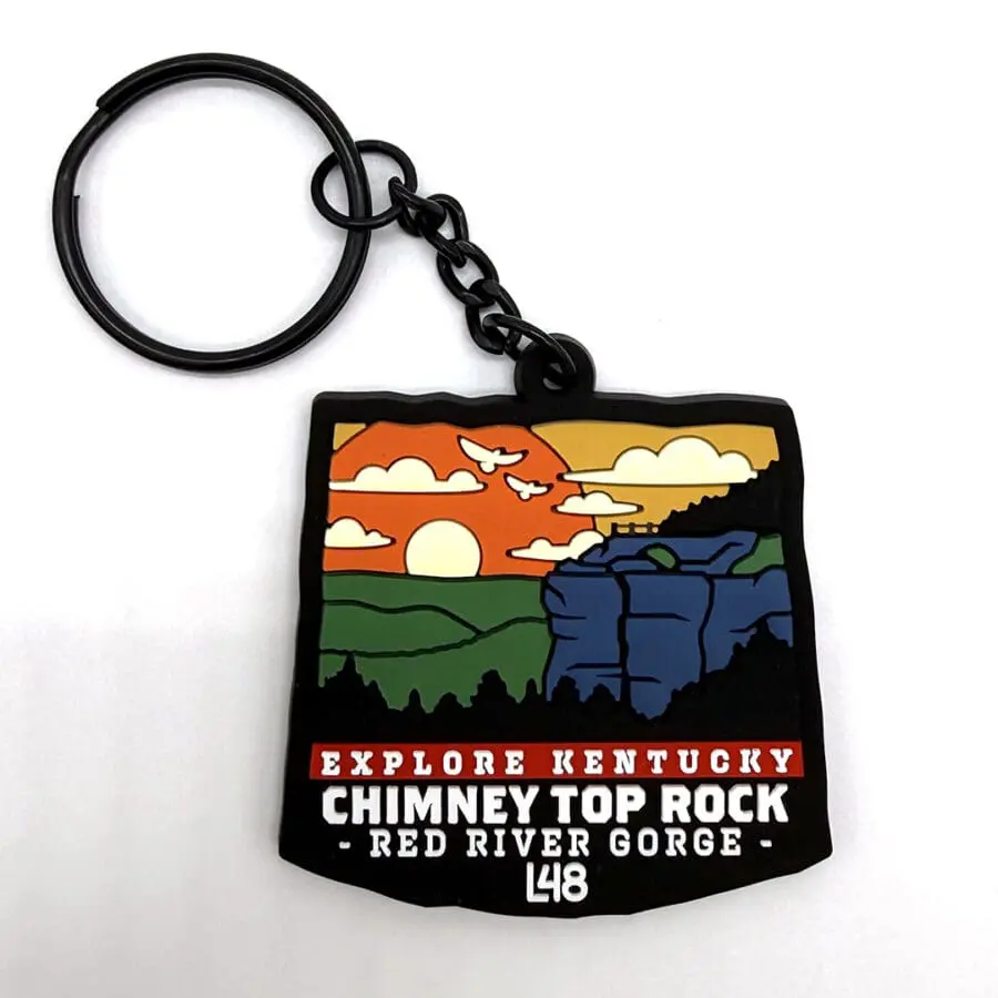Souvenir Keychain with a Colorful Sunset Landscape of Chimney Top Rock at Red River Gorge, Kentucky, and the Text 'explore Kentucky Chimney Top Rock Red River Gorge L48'.