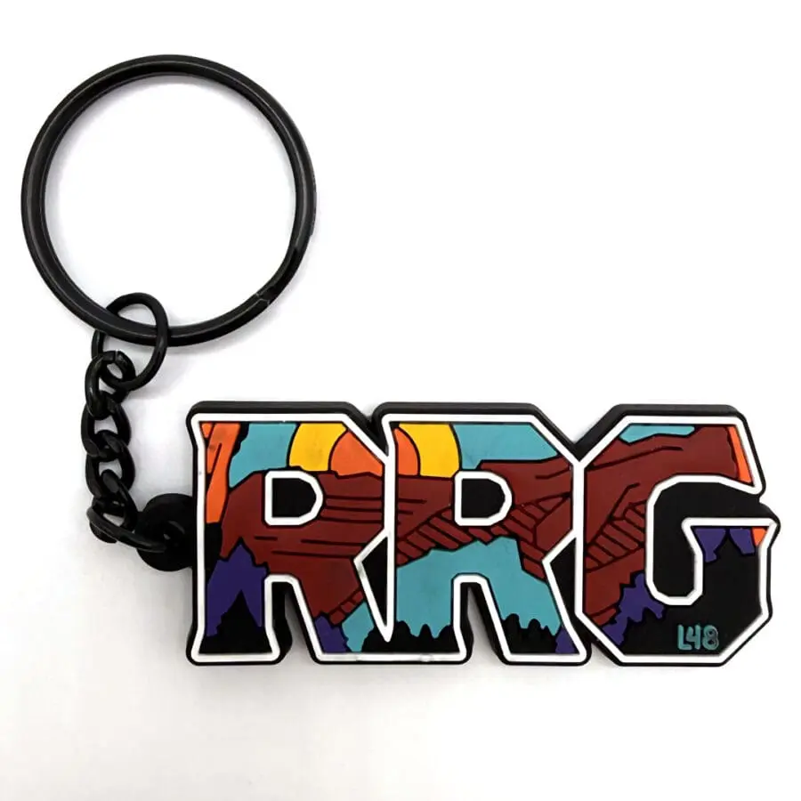 Colorful Prg Keychain with Bold Outlined Letters and a Mountain Landscape Pattern in Orange, Teal, Purple, and Black Backgrounds
